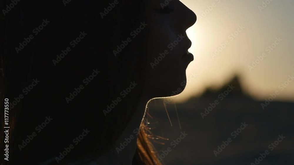 silhouette of professional dancer girl on the beach at sunset in slow motion silhouette of professional dancer girl on the beach at sunset in slow motion