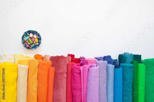 Rolls of bright colored fabric on a white background. photo