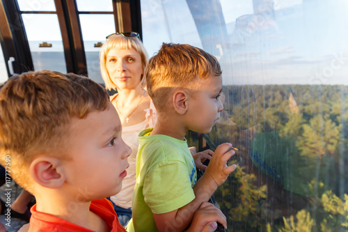 Brothers-twins and ride with mom on the cable car