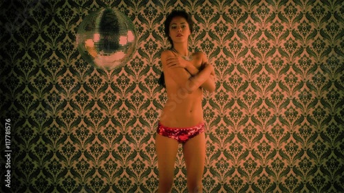 topless woman dancing covering with her hands