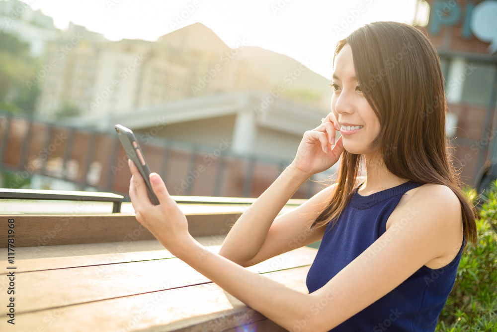 Fototapeta premium Woman using mobile phone at outdoor