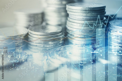Double exposure of city and rows of coins for finance and banking concept

 photo