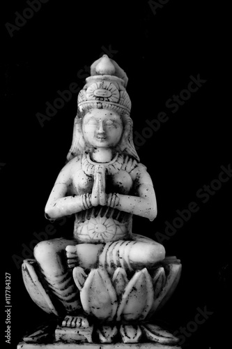 A small marble deity of the Hindu goddess Lakshmi the giver of wealth.