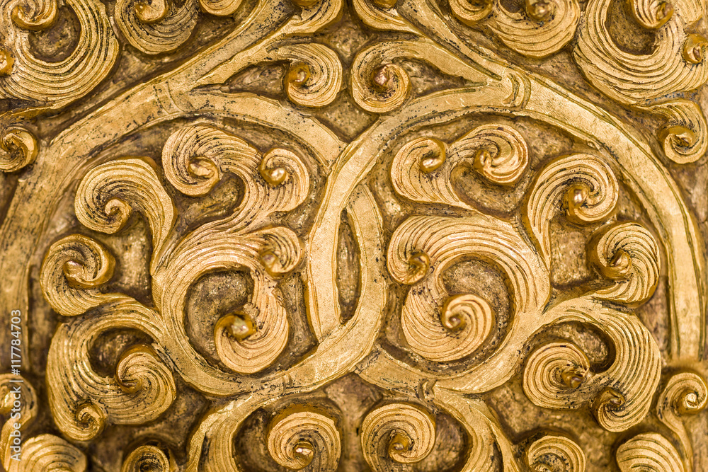 Swirling gold metalwork design.
