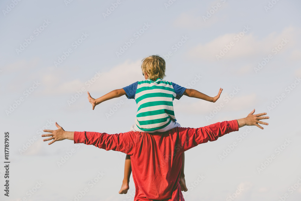happy father and son playing on sky happy father and son playing on sky