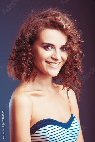 Beautiful portrait curly girl model with makeup and a pretty smile