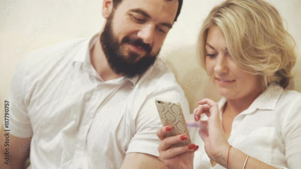 Woman shows sth on phone to his colleague Woman shows sth on phone to his colleague