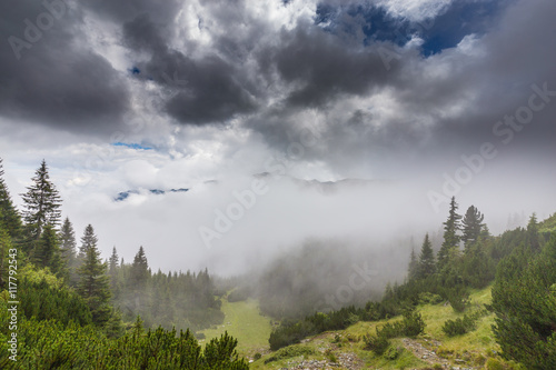 Mountain scenery in the Transylvanian Alps in summer, with mist clouds