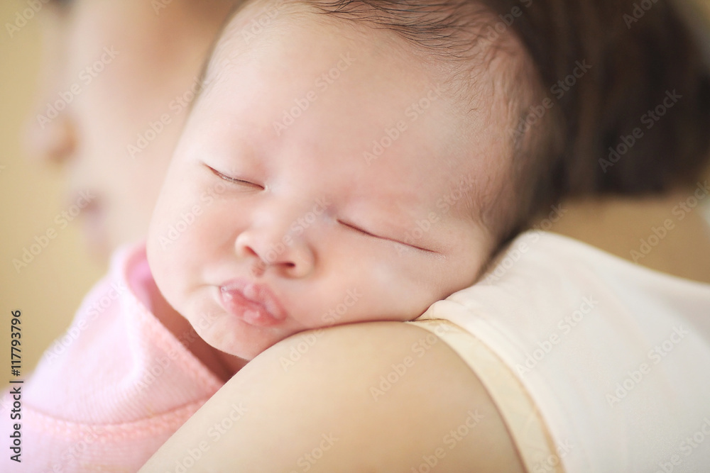 Asia baby sleeping in a warm embrace of mother. Asia baby sleeping in a warm embrace of mother.