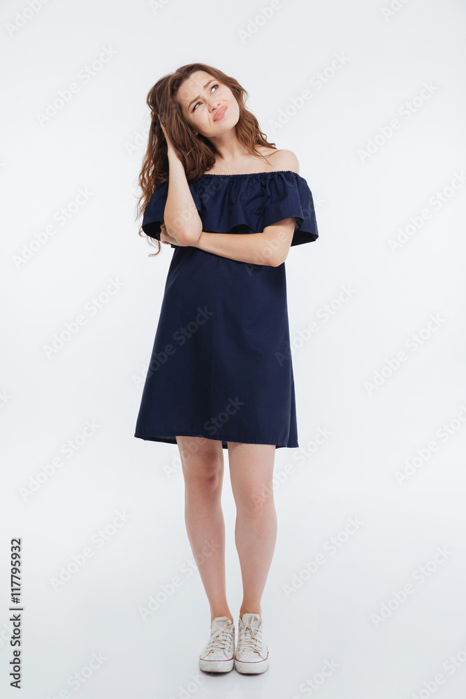 Thoughtful frowning young woman standing and thinking Thoughtful frowning young woman standing and thinking