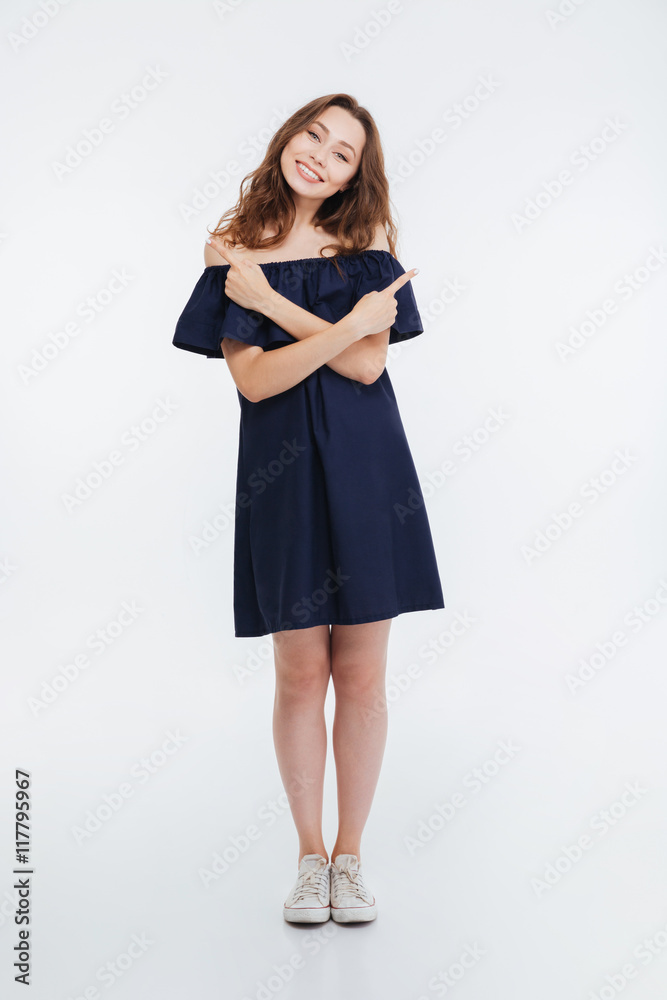 Cheerful lovely young woman pointing left and right Cheerful lovely young woman pointing left and right