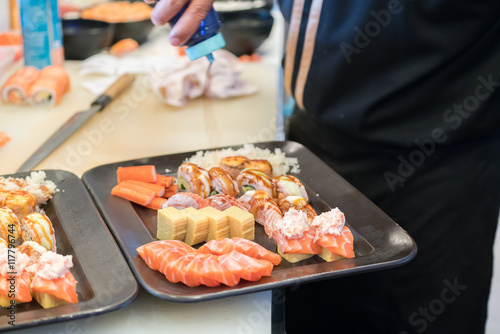 preparing sushi in restaurant kitchen
