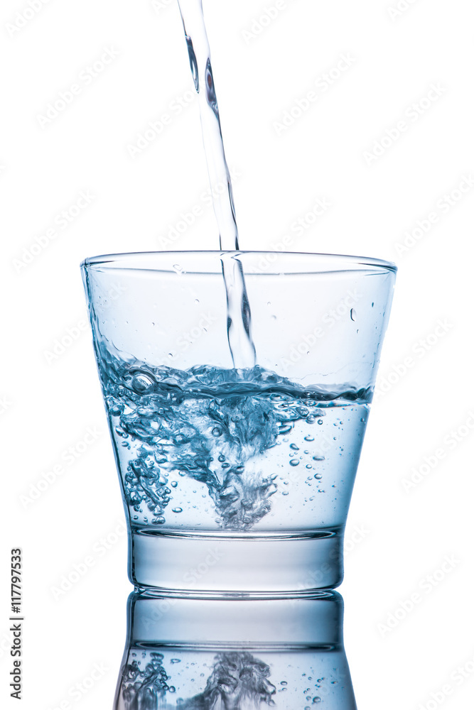 Drinking water is poured into a glass Drinking water is poured into a glass