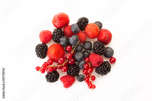 mixed red and black fruit in a circle on a white background
