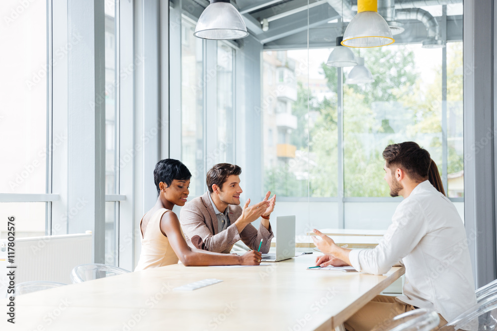 Businesspeople working in office and discussing new ideas Businesspeople working in office and discussing new ideas