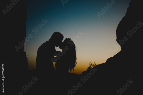 Kissing couple in twilight photo