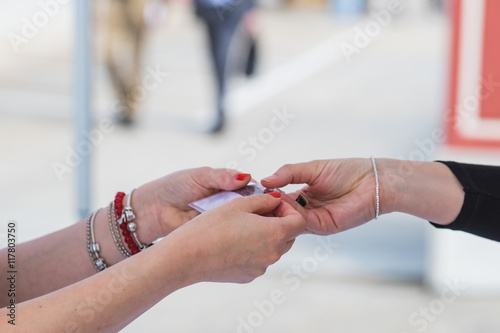 Woman hands handing a badge