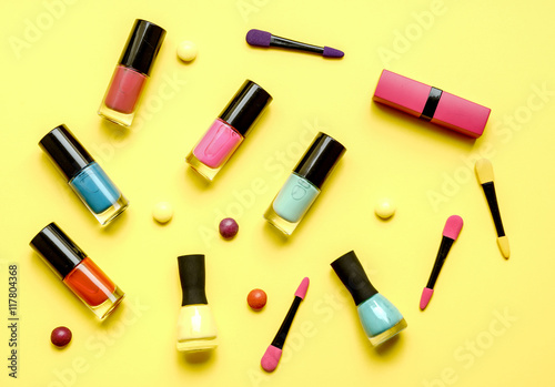 make up set on yellow background top view