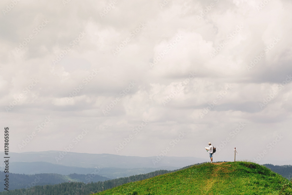 hipster traveler on top of mountains with amazing view and holdi hipster traveler on top of mountains with amazing view and holdi