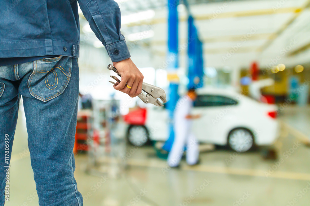 Hand with wrench. Auto mechanic in car repair Hand with wrench. Auto mechanic in car repair