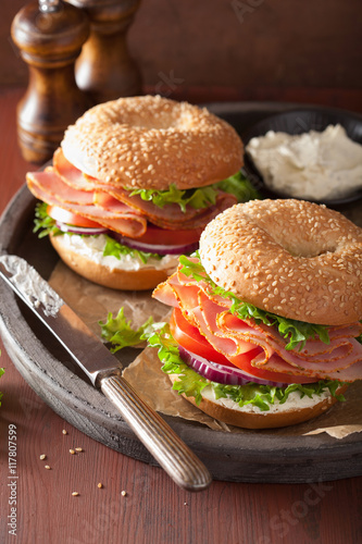 ham sandwich on bagel with cream cheese tomato onion