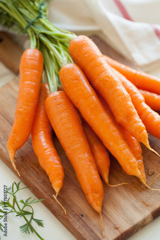 raw carrot vegetable on wooden chopping board raw carrot vegetable on wooden chopping board