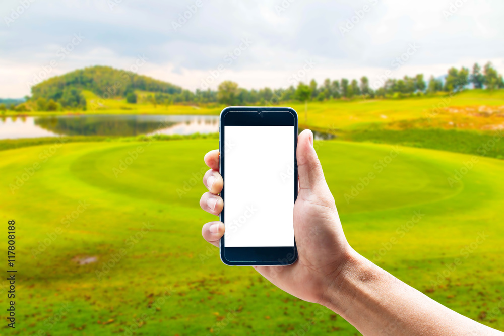 Hand using smartphone mobile in the vertical position, background blur of golf. Hand using smartphone mobile in the vertical position, background blur of golf.