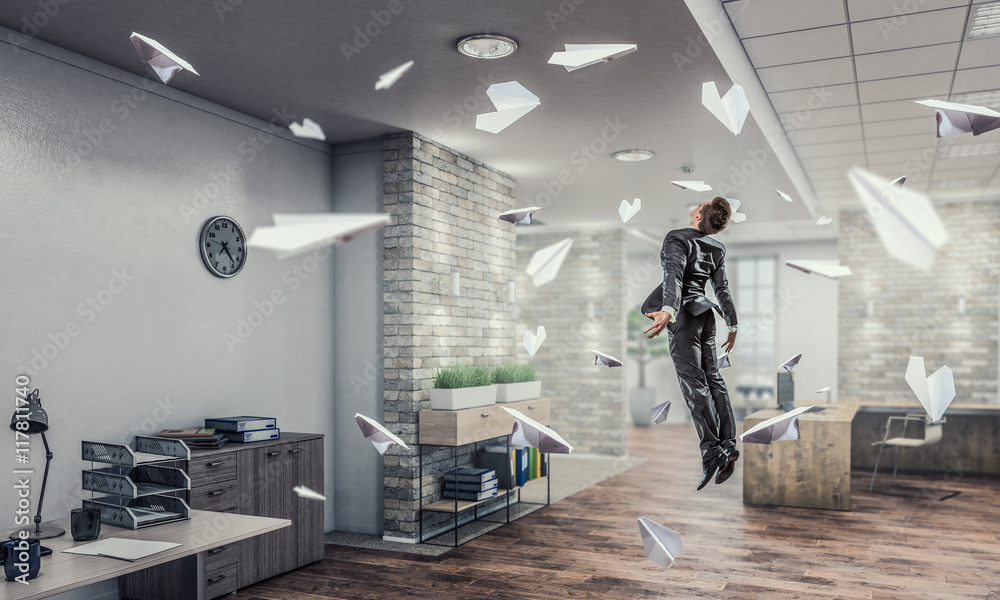 Jumping businessman in office . Mixed media Jumping businessman in office . Mixed media