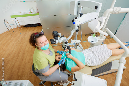 Top view.Treatment of dental caries in a dental clinic. Woman de