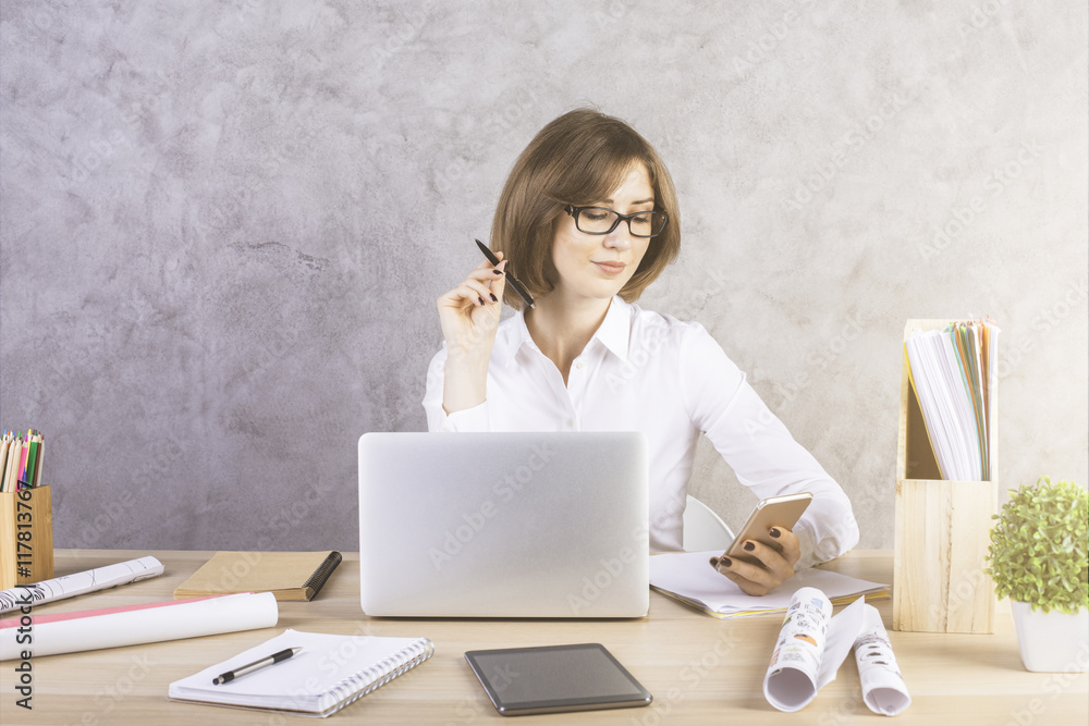 Businesswoman with smartphone doing paperwork Businesswoman with smartphone doing paperwork