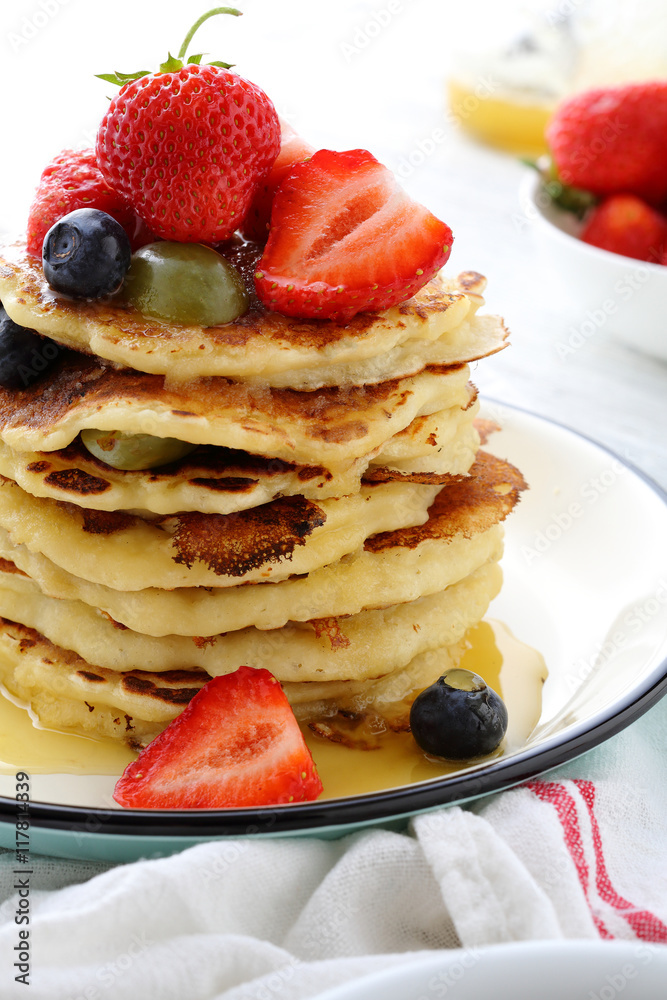 Stack of breakfast pancakes with fruits and sauce Stack of breakfast pancakes with fruits and sauce