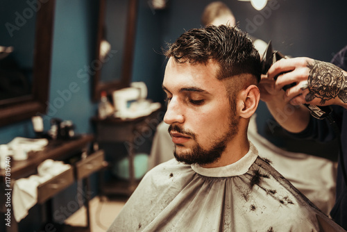 Hairdresser makes hair short man