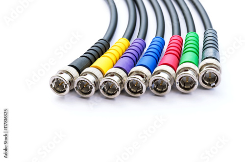 Group of BNC connector jacks different color with cable for video signal isolated on white background.