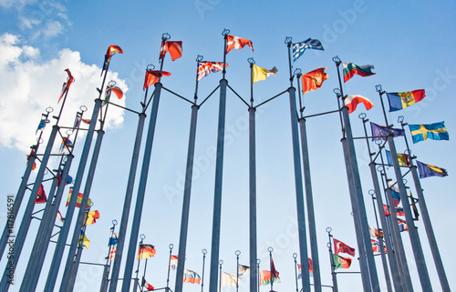flags on background of the blue sky with clouds