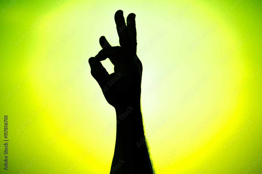 Silhouette of a team of people hands shows gesture ok