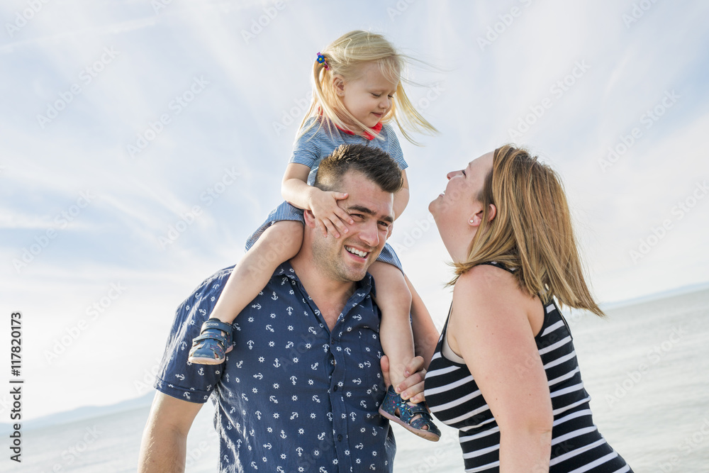 Family of three on beach having fun together Family of three on beach having fun together