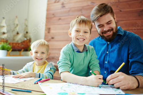 Man and boys drawing