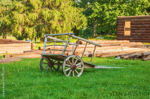 Old wooden carriage stands on the lawn