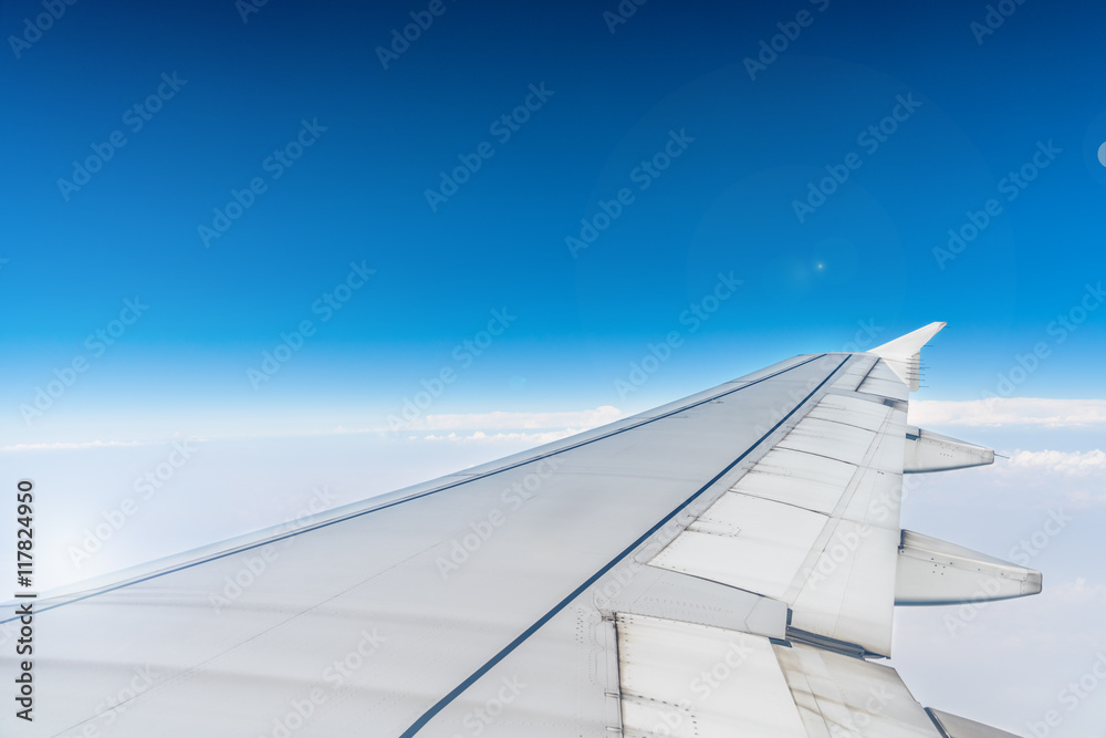 View of the wing through an airplane window View of the wing through an airplane window