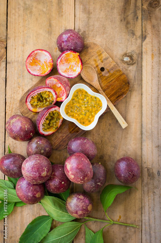 Fototapeta Naklejka Na Ścianę i Meble -  Fresh passion fruits on a wooden background