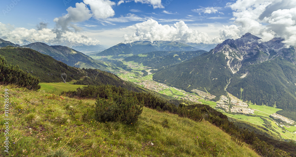 Mountain landscape with trail, green meadow and forest Mountain landscape with trail, green meadow and forest