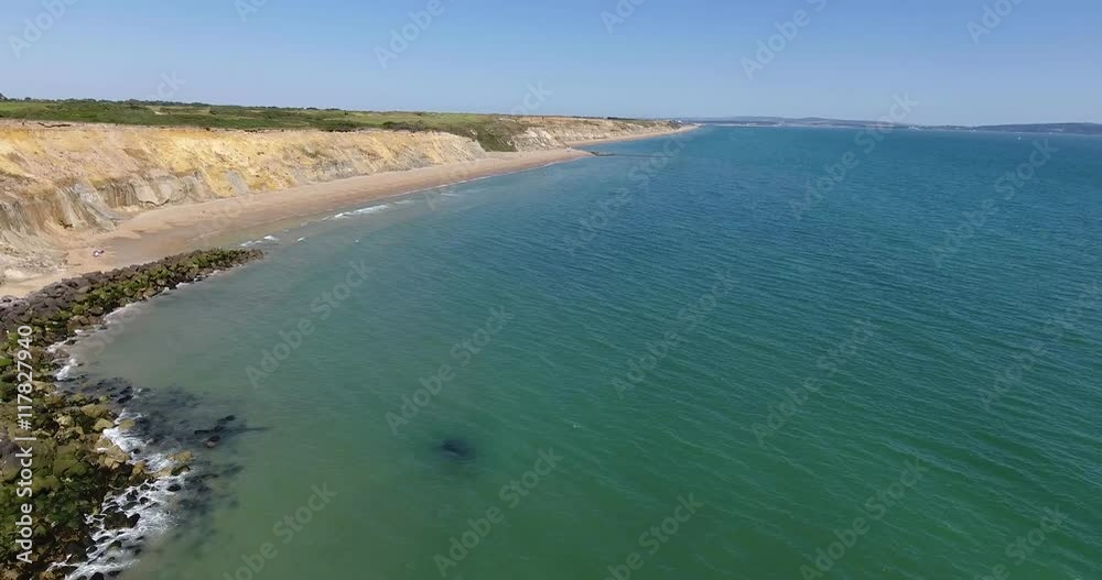 Aerial view of a coastal protection barrier in the form of large rocks to prevent erosion along cliffs and coastline Aerial view of a coastal protection barrier in the form of large rocks to prevent erosion along cliffs and coastline