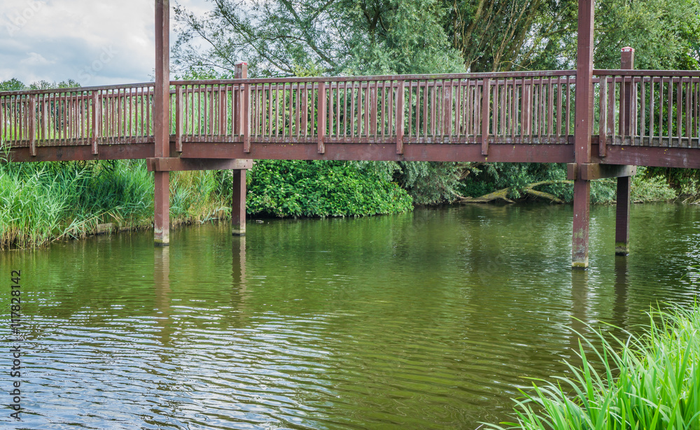 wooden bridge with poles water view