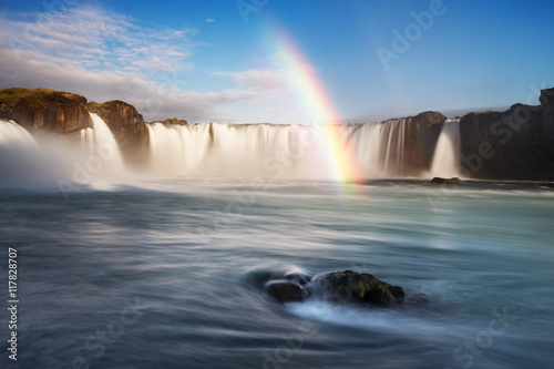 Godafoss waterfall and rainbow on a sunny morning