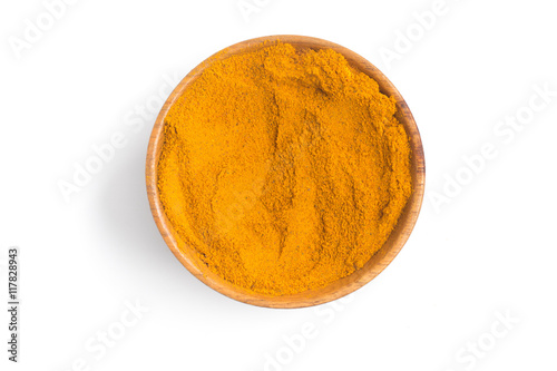 Turmeric powder into a bowl in white background photo