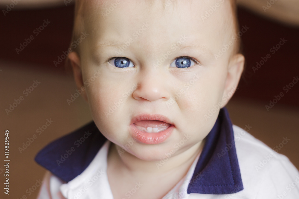 Baby boy with two teeth is looking at the camera Baby boy with two teeth is looking at the camera
