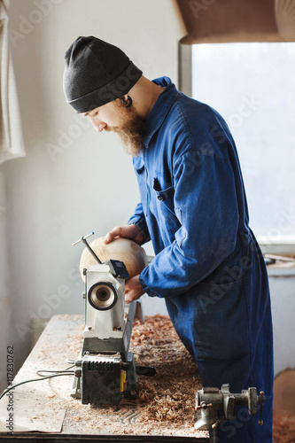 A man working with woodcarving instruments