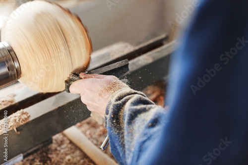 A man working with woodcarving instruments photo