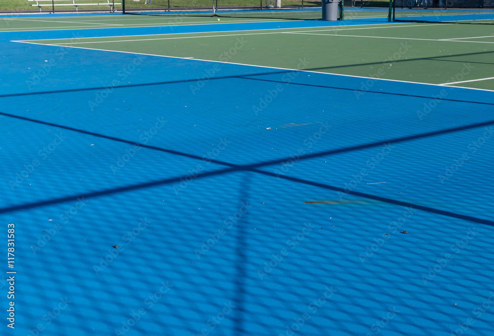 Obraz premium Abstract image of tennis court and tennis equipment. Light and shadow on tennis court. Daylight on a tennis court. Outdoors sport. Minimal art and design. 