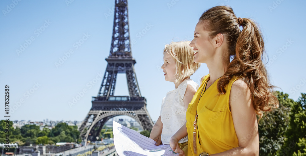 mother and daughter looking into distance and holding map, Paris